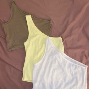 One shoulder crop tops in yellow, brown, and white